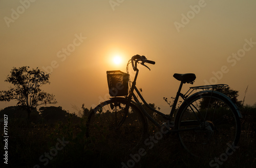 Bicycle with sun set background © guykantawan