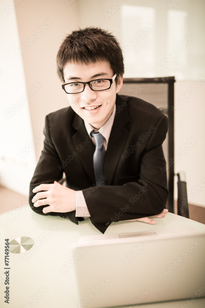 Young handsome man using laptop in his office Young handsome man using laptop in his office