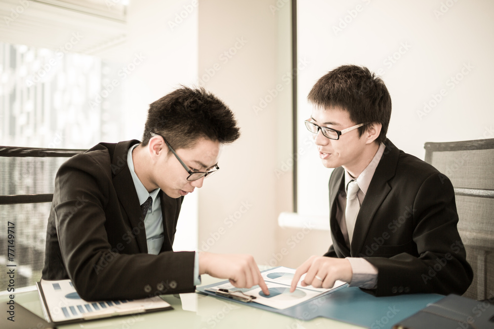 Two Businessmen Having Informal Meeting In Modern Office Two Businessmen Having Informal Meeting In Modern Office