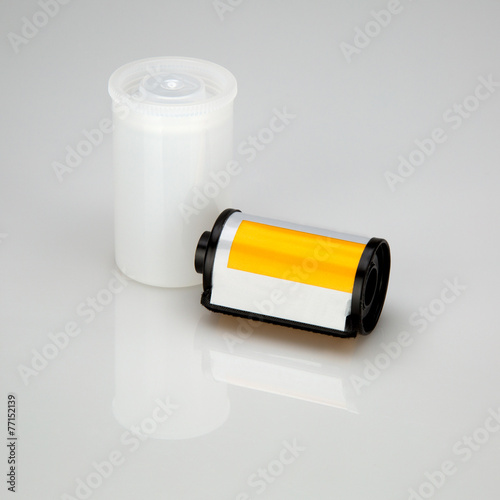 35 mm camera film is lying near jar, isolated on white backgroun photo