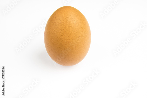 Whole brown hens egg on a white background