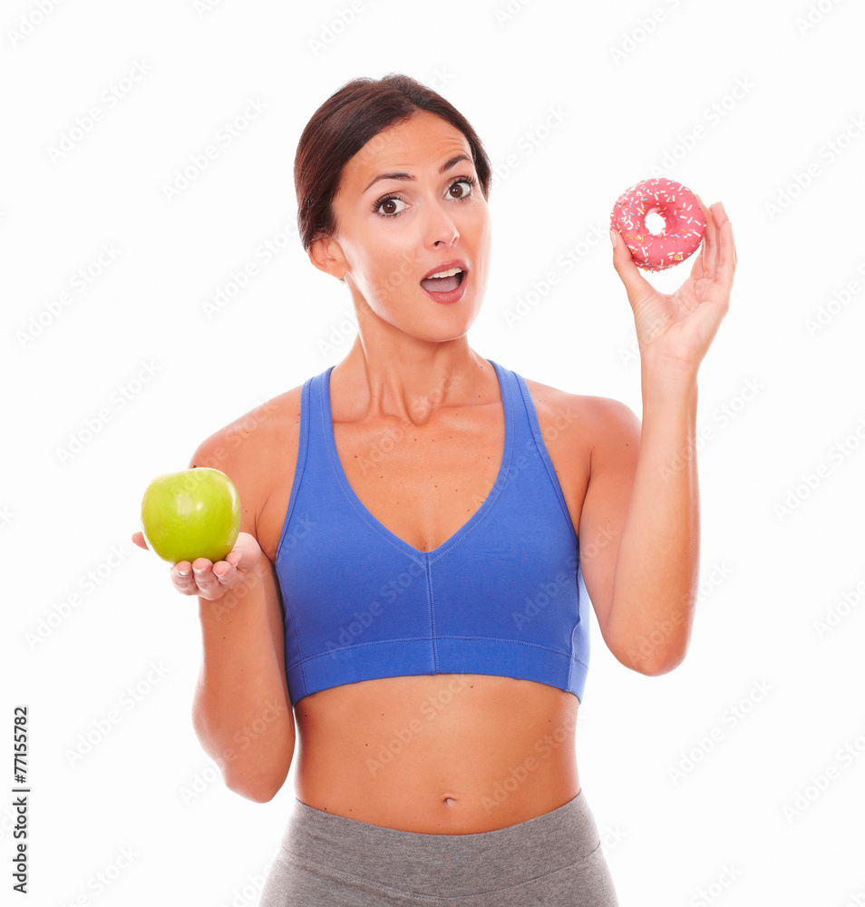 Surprised young woman holding food temptations Surprised young woman holding food temptations