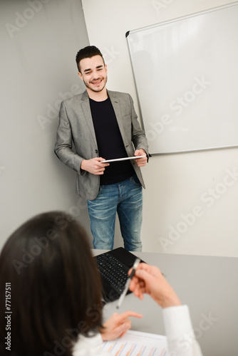 young business man or teacher showing on white board