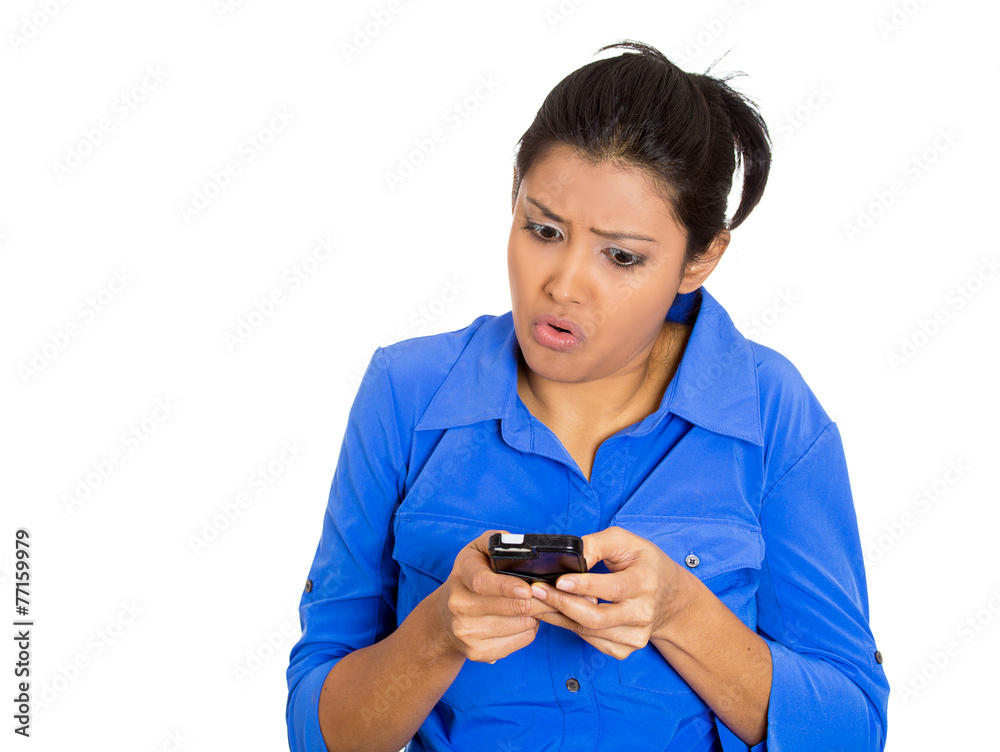 Angry displeased young woman texting on mobile phone Angry displeased young woman texting on mobile phone
