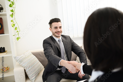 young agent salesman shaking hands at a customer home