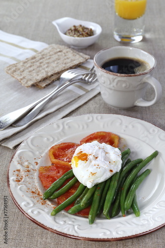 Healthy  breakfast: vegetables, poached egg, cup of coffee and j
