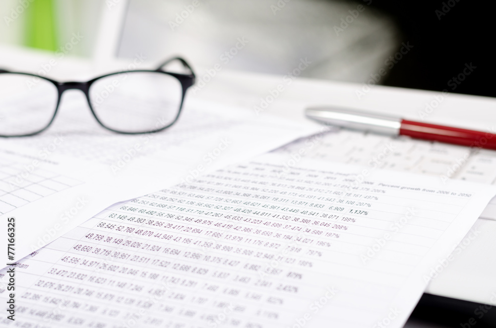 Business composition with laptop glasses pen and statistics shee Business composition with laptop glasses pen and statistics shee