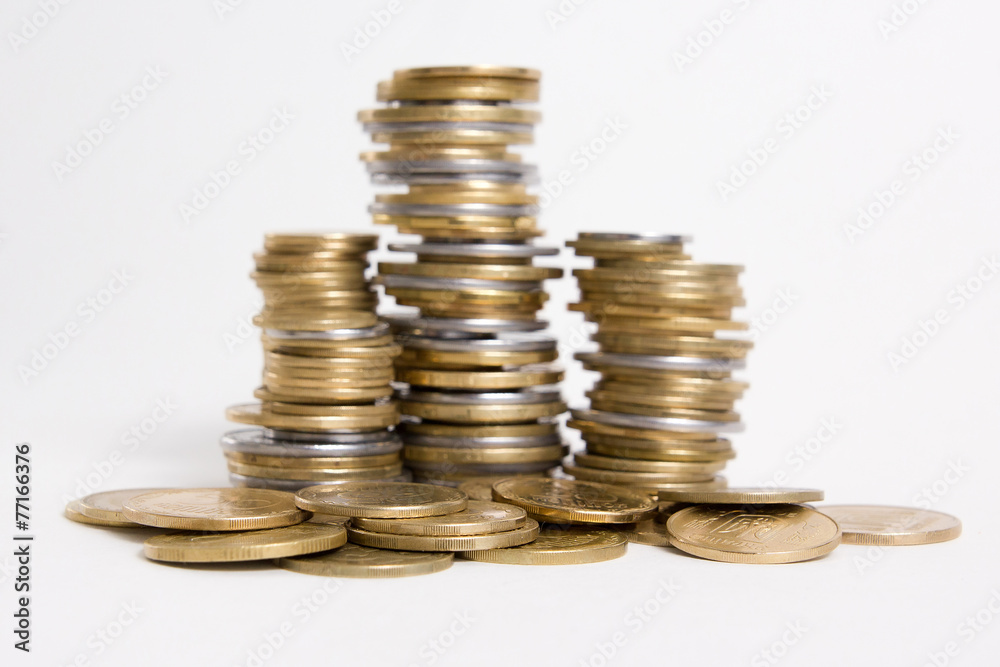 Columns of coins isolated on white background