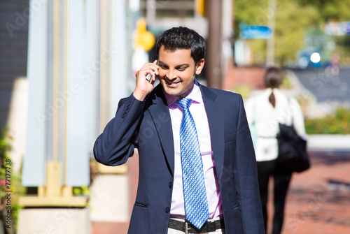 happy  smiling business man talking on his phone
