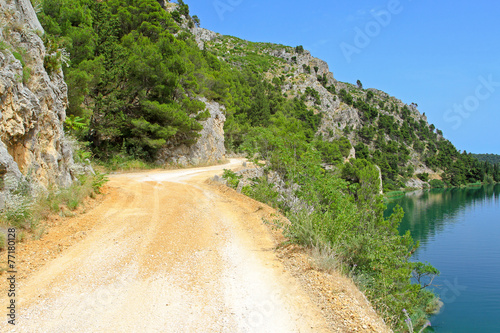 Dirt road by lake