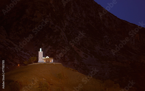 Morocco. Chefchaouen. Lone mosque Bouzaafer on top of the hill photo