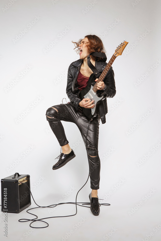 Fototapeta premium Young guitar player isolated on grey