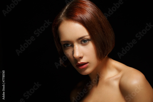 Beautiful young woman on dark background