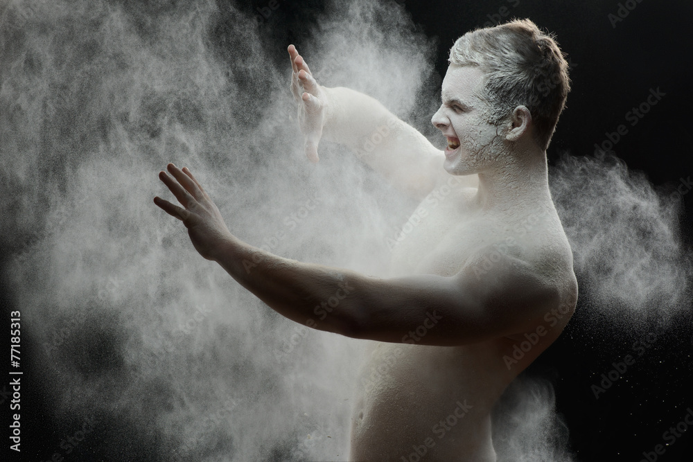 Handsome frozen man with a white powder on his body