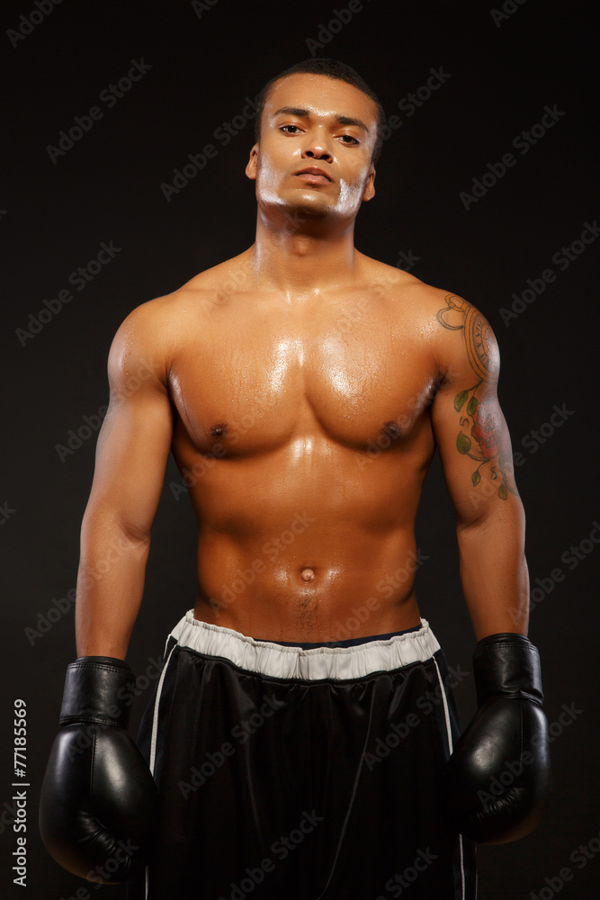 Fototapeta premium Handsome boxer posing in boxing gloves