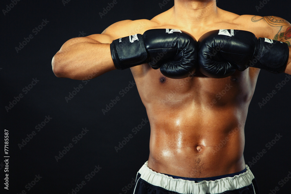 Naklejka premium Handsome boxer posing in boxing gloves