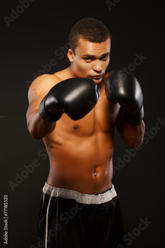 Handsome boxer posing in boxing gloves