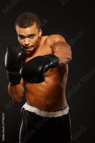 Handsome boxer posing in boxing gloves