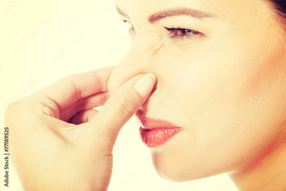 Obraz premium Woman with grimace because of bad smell.