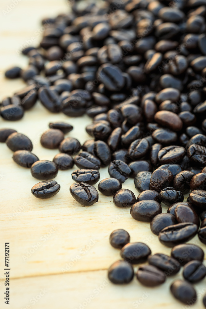 Close up roasted coffee beans on wooden background Close up roasted coffee beans on wooden background