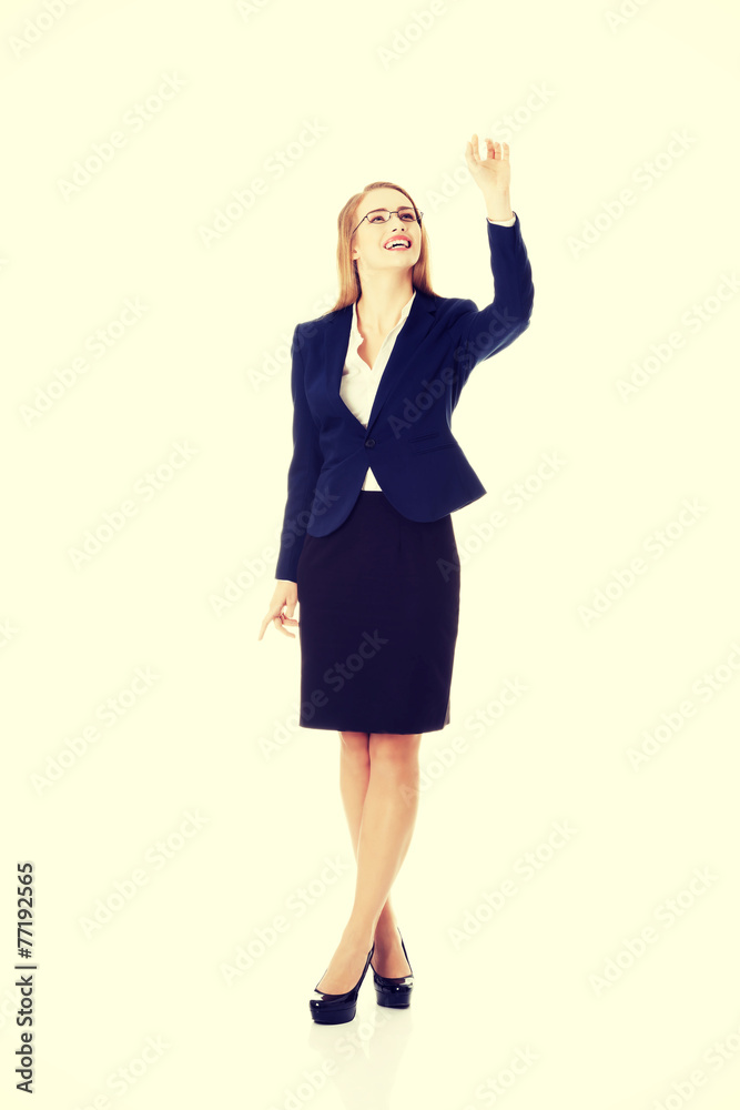 Beautiful businesswoman touching an abstract space Beautiful businesswoman touching an abstract space