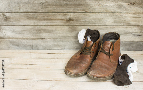 Still Life brown leather men's boots on wood background
