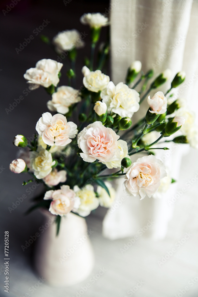 delicate bouquet of carnations in a vase vintage. romance