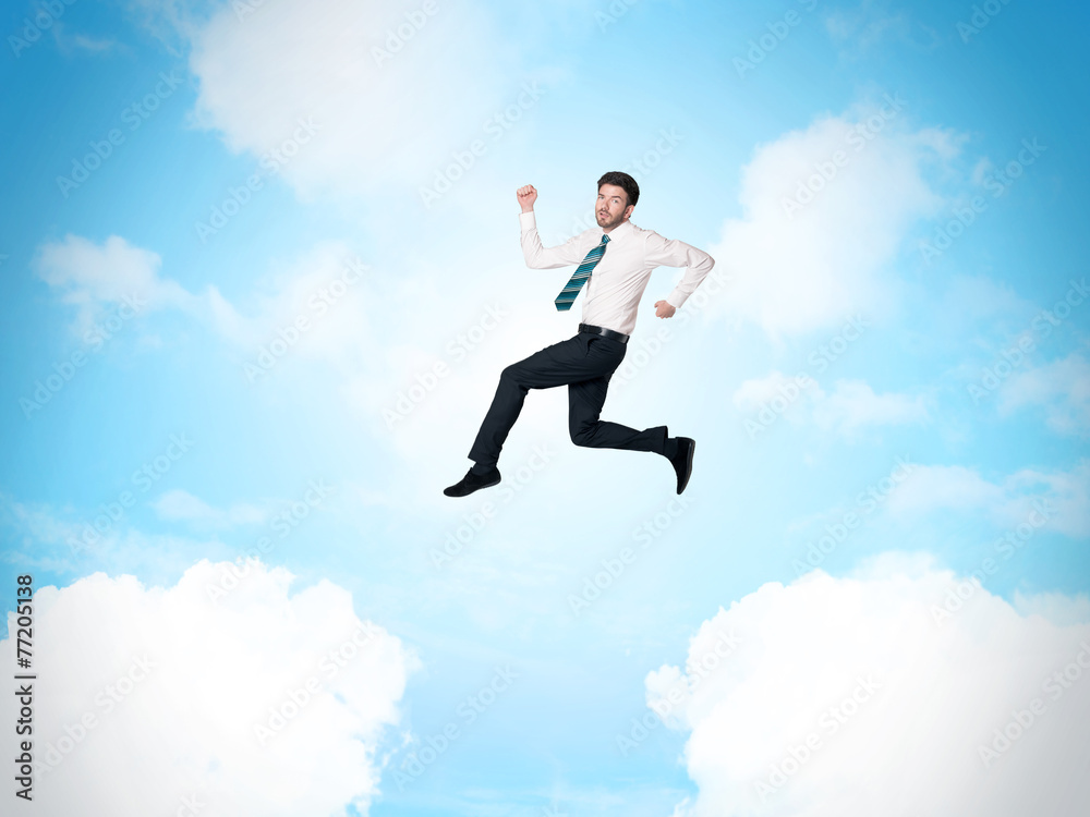 Business person jumping over clouds in the sky Business person jumping over clouds in the sky