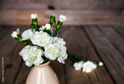 delicate bouquet of carnations in vintage vase with heart © serbogachuk