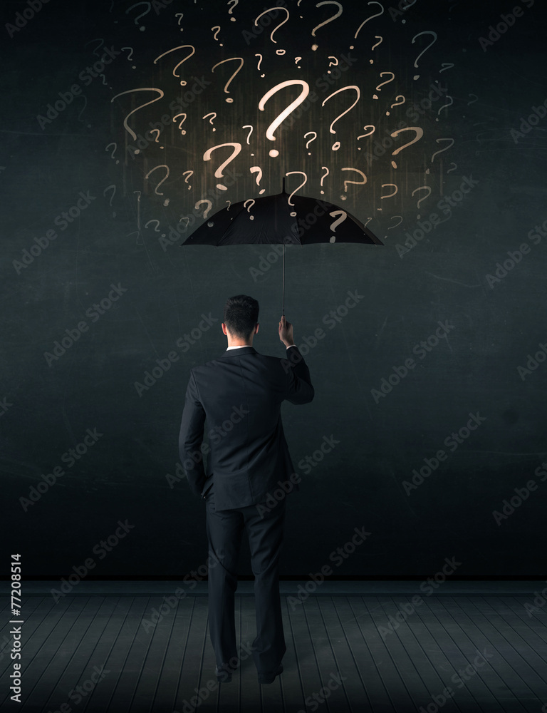 Businessman with umbrella and a lot of drawn question marks