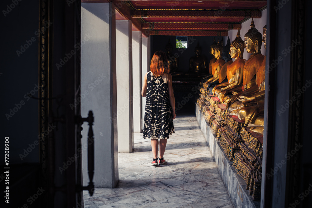 Fototapeta premium Woman exploring buddhist temple