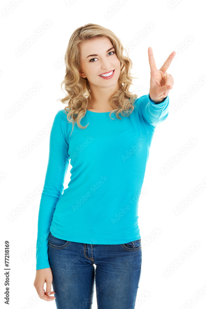 Young woman showing victory sign Young woman showing victory sign