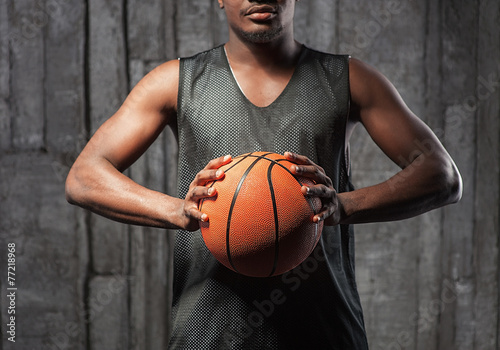 Afro-american basketball athlete gripping the ball