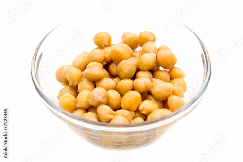 Chickpeas on glass bowl on white background