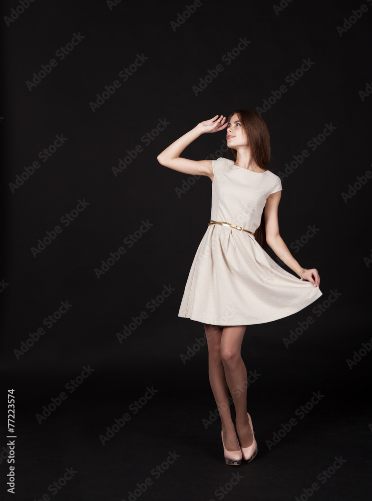 young beautiful girl in a light dress looking up