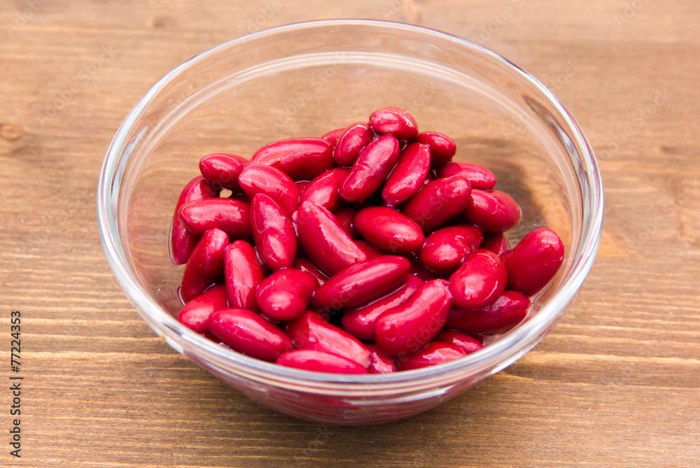 Red beans on bowl on wooden table