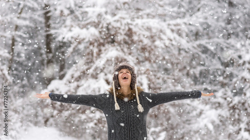 Happy vivacious woman celebrating the snow