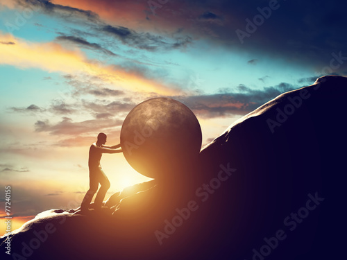 Sisyphus metaphor. Man rolling huge concrete ball up hill.