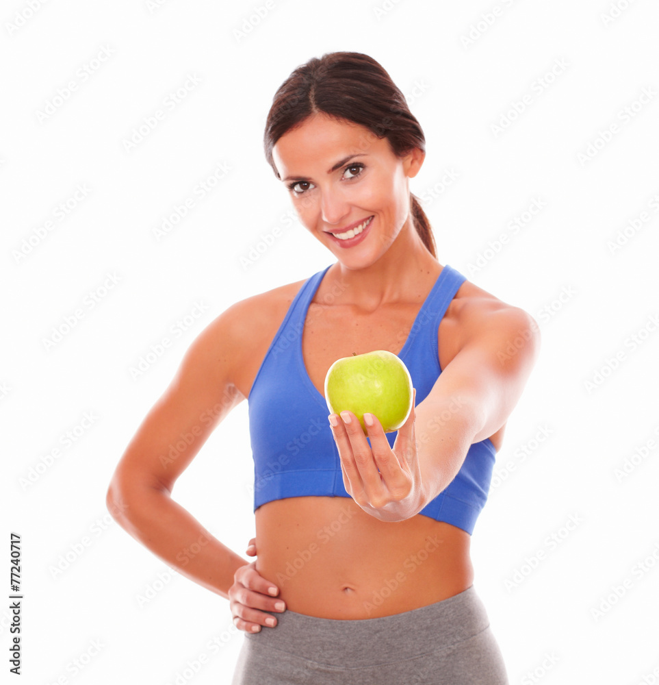 Lady in sportswear holding apple on left hand Lady in sportswear holding apple on left hand