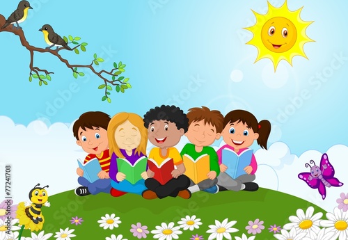 Happy children sitting on the grass while reading books