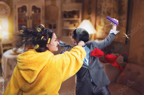 Фотография Woman beats her husband with pan