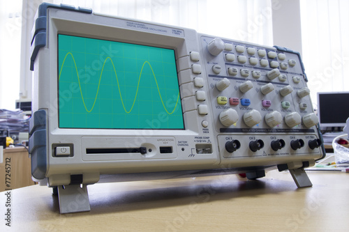 Oscilloscope with sine wave illustration