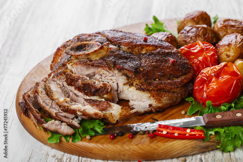 roasted pork shoulder on the bone with potatoes