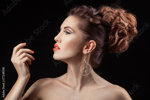 Girl in profile with a coral lip color.