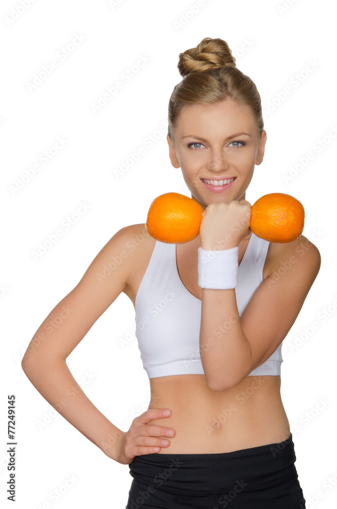 Beautiful woman with dumbbells two oranges Beautiful woman with dumbbells two oranges
