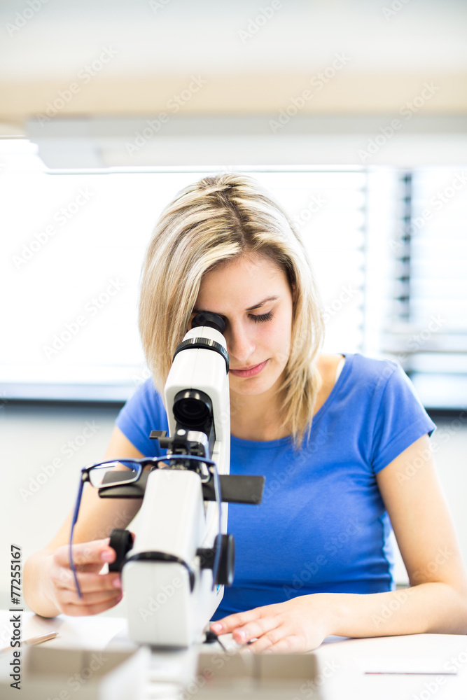 Pretty, female optometrist measuring newly made glasses Pretty, female optometrist measuring newly made glasses