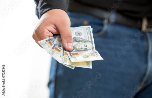 man showing hand with hundred dollar banknotes