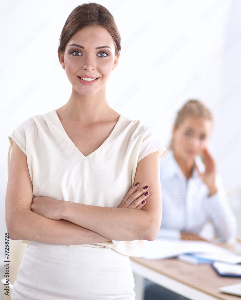 Attractive businesswoman with her arms crossed  standing in