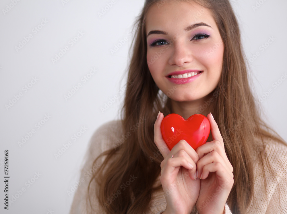 Portrait of beautiful happy woman holding a symbol heart. Portrait of beautiful happy woman holding a symbol heart.