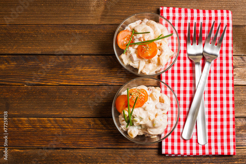 Pasta salad on wooden background, top view